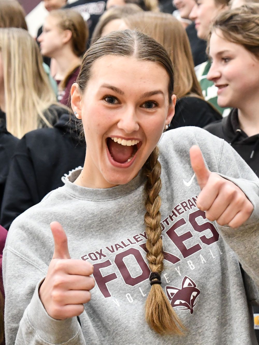 Enthusiastic female student with her thumbs up and wearing an FVL shirt