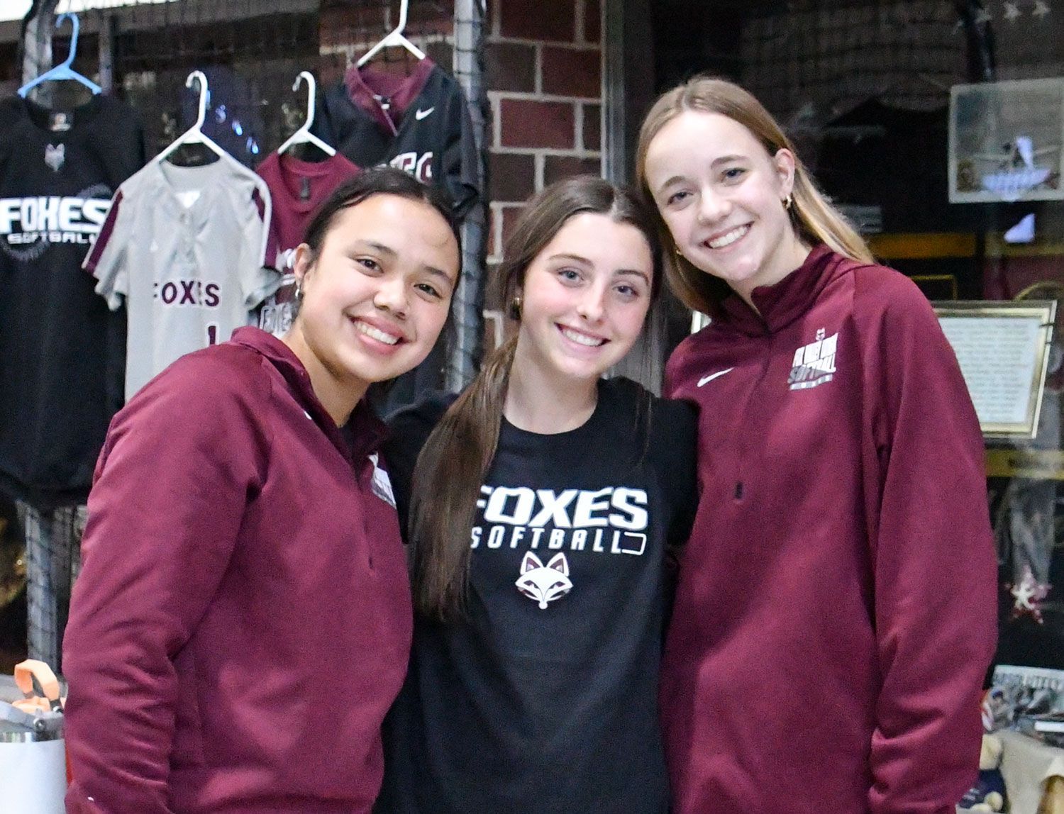 Three smiling female FVL students, ready to talk to visitors