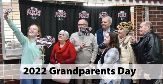 Student and grandparents at a photo stop, taking a selfie during Grandparents Day in 2022