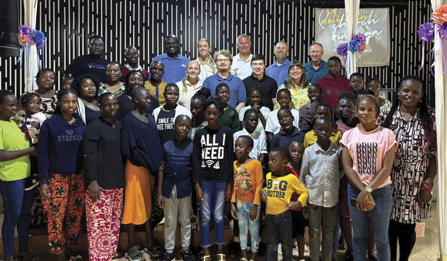 Large group of locals with our visiting FVL students, in a building