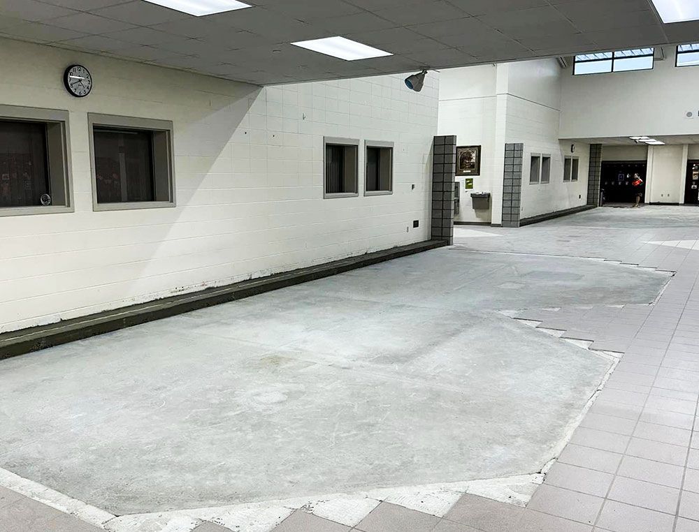 The pits, filled in with concrete, and in need of tiling and lockers