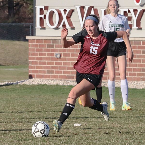 Member of the FVL girls soccer team running and dribbling a soccer ball during a game  at FVL