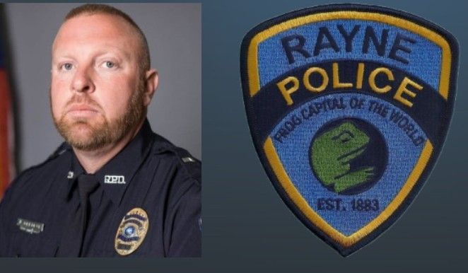 A man in a police uniform next to a rayne police patch