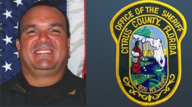 Woman in front of American flag and Timber Mesa Fire logo.