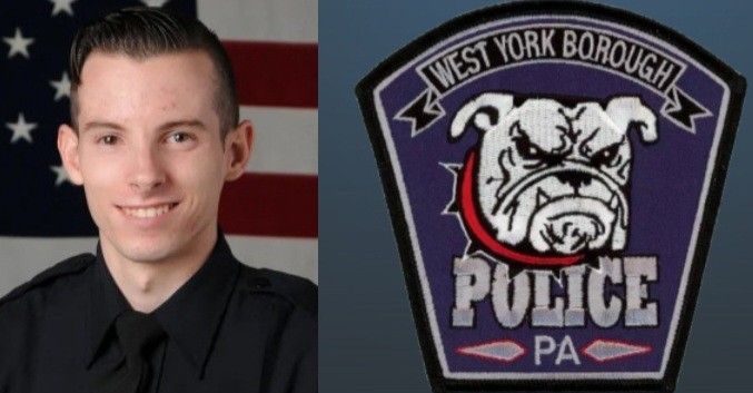 A virginia beach police officer is smiling in front of an american flag