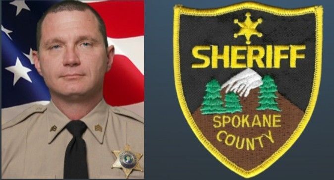 Portrait of a Spokane County Sheriff in uniform next to the department's patch. American flag in the background.