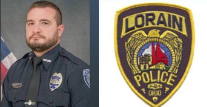 Lorain, Ohio police officer in uniform next to police badge.