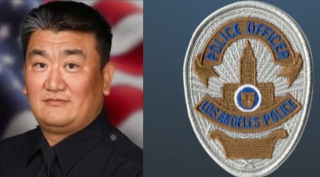 A man next to a los angeles police badge