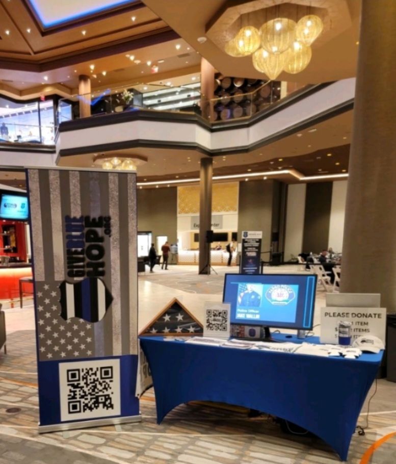 A table in a mall with a sign that says donate hope