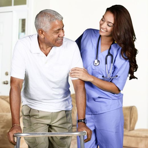 a nurse helps an elderly man with a walker