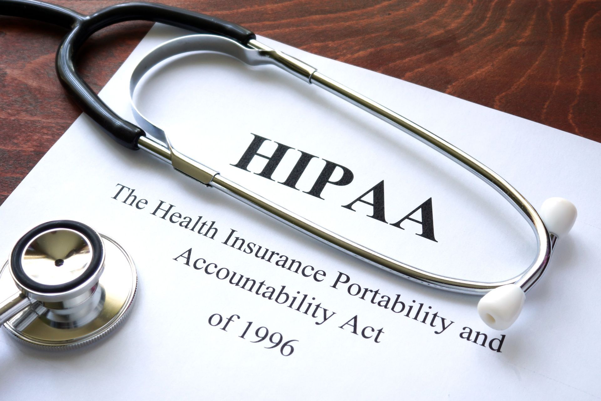 a stethoscope rests on a piece of paper that says hipaa