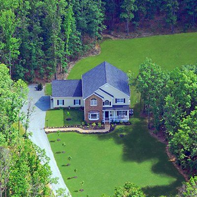Big house in a green field — building remodeling & repair contractors in Chartlottesville, VA