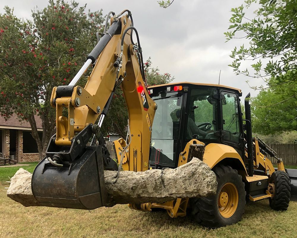 Tractor Moving Big Rock — Harlingen, TX — Abundiz Tractor Services