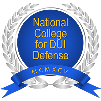 Logo for the National College for DUI Defense: blue circle with gold text and banner, surrounded by silver wreath.