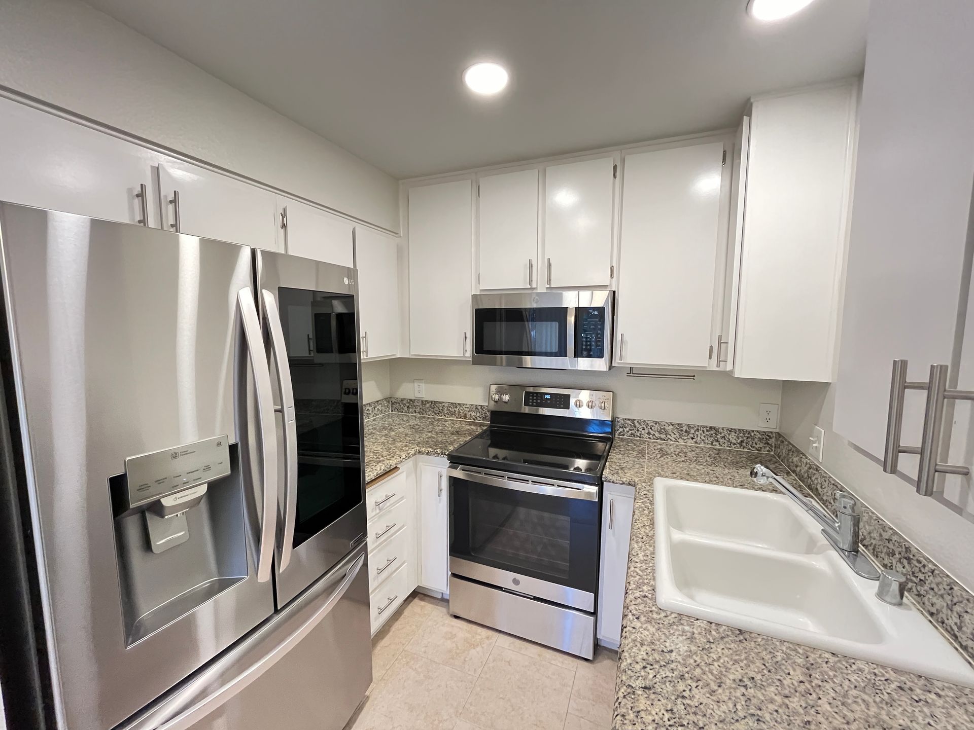 A kitchen with stainless steel appliances and granite counter tops
