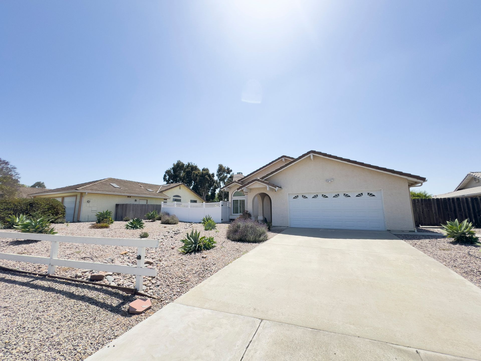 A white house with a white fence in front of it
