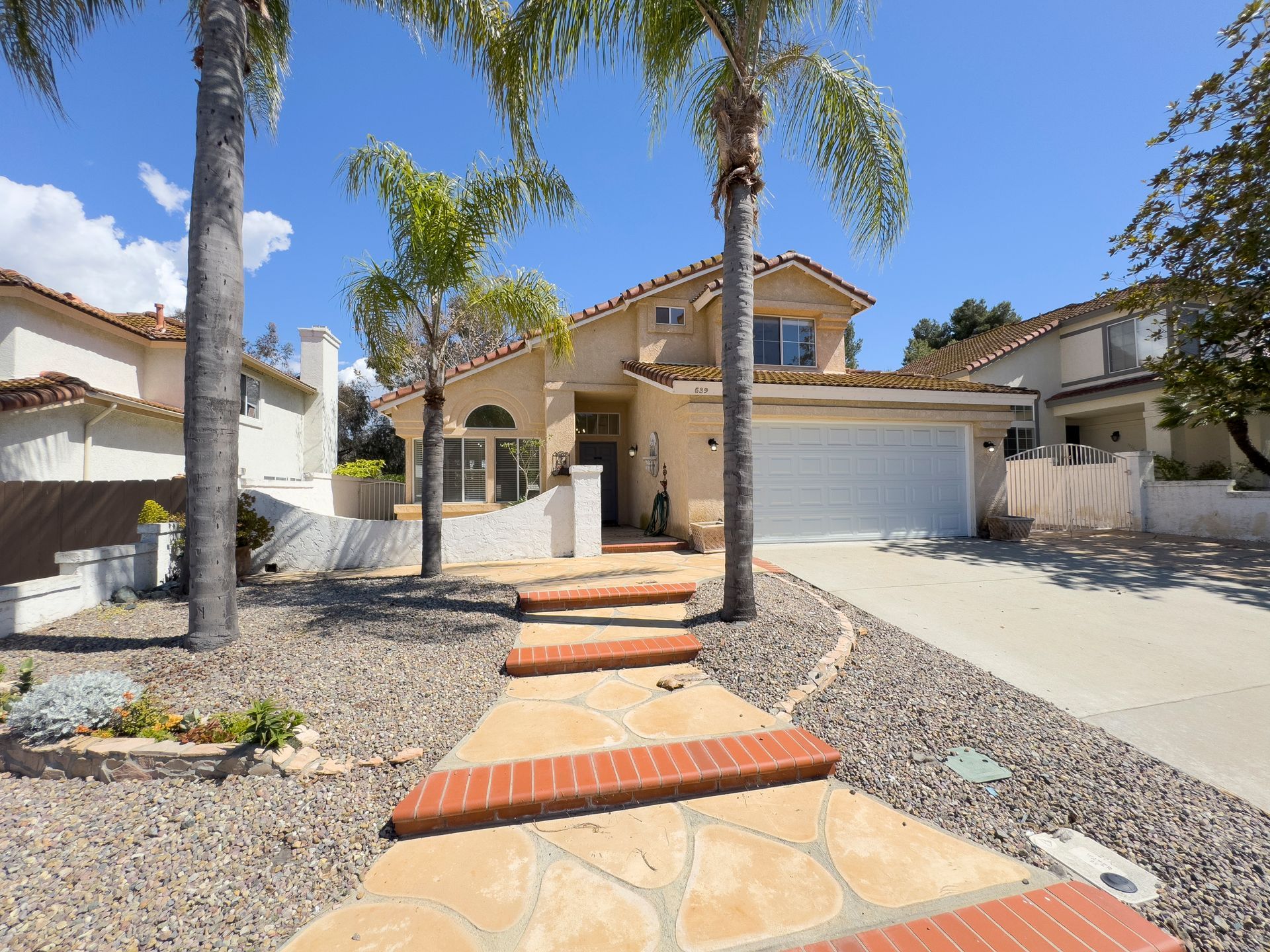 A house with palm trees in front of it