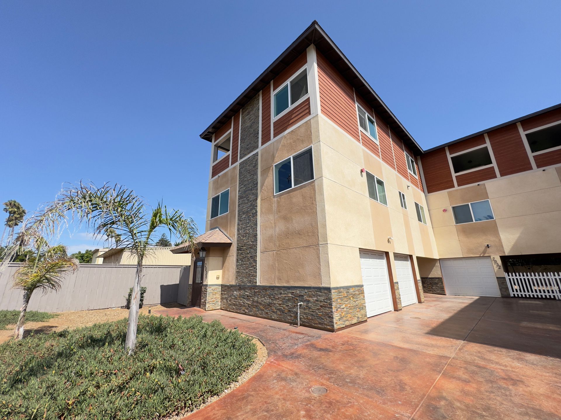 A large building with a lot of windows and a tree in front of it