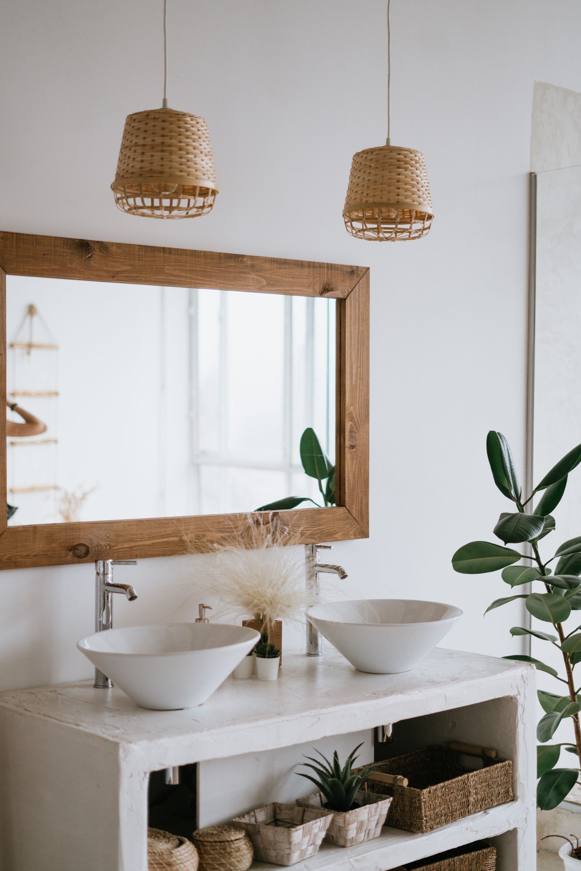 A bathroom with two sinks and a large mirror.