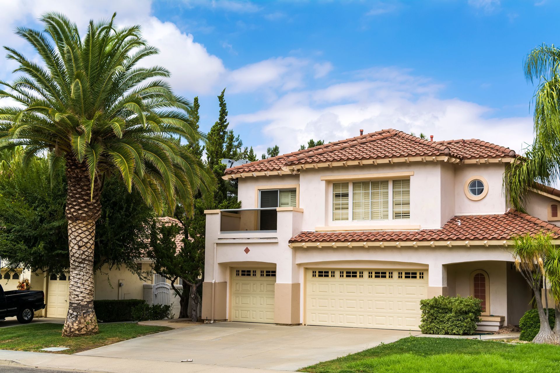 A large house with a palm tree in front of it