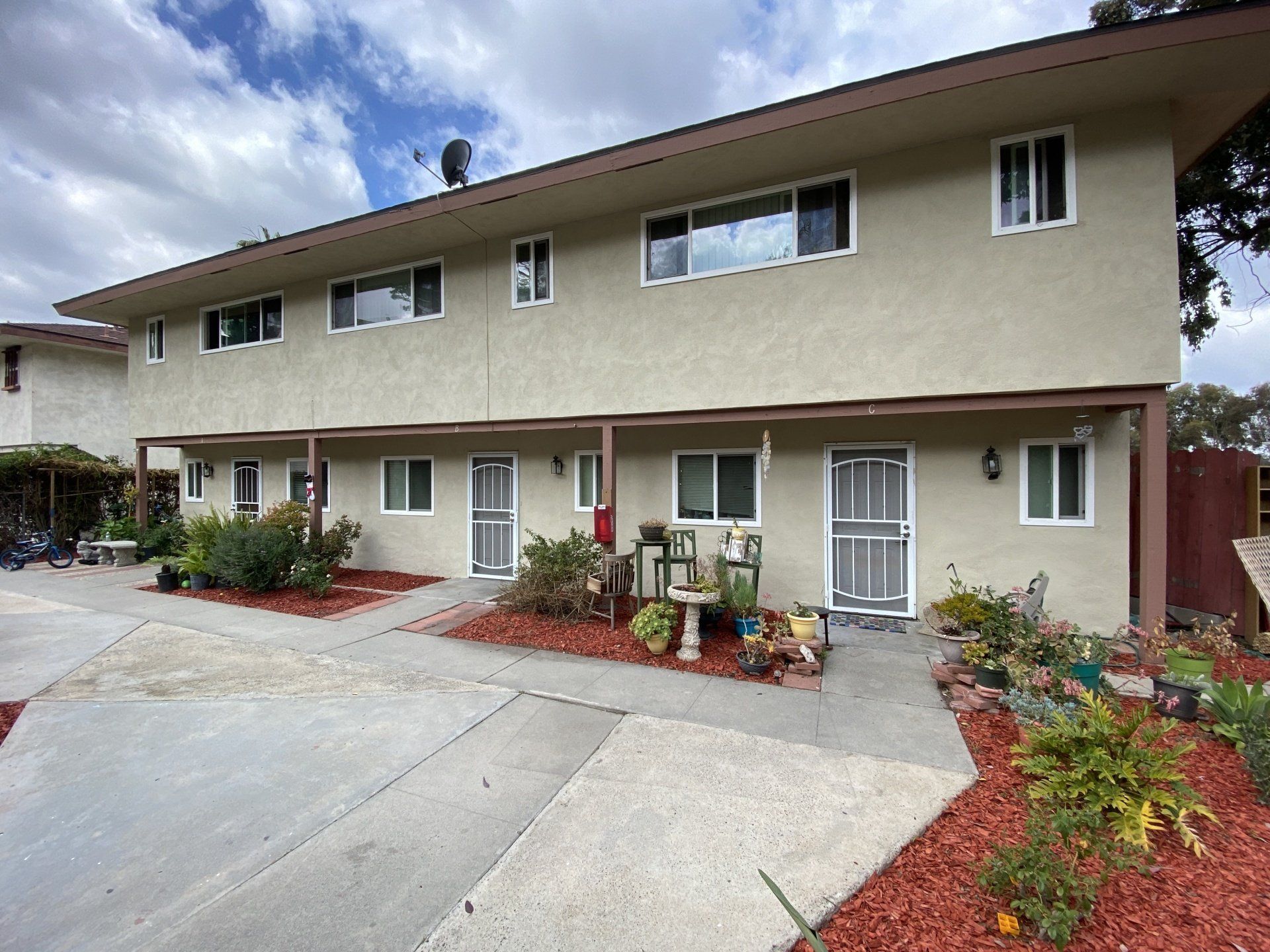 A building with a lot of windows and a walkway in front of it