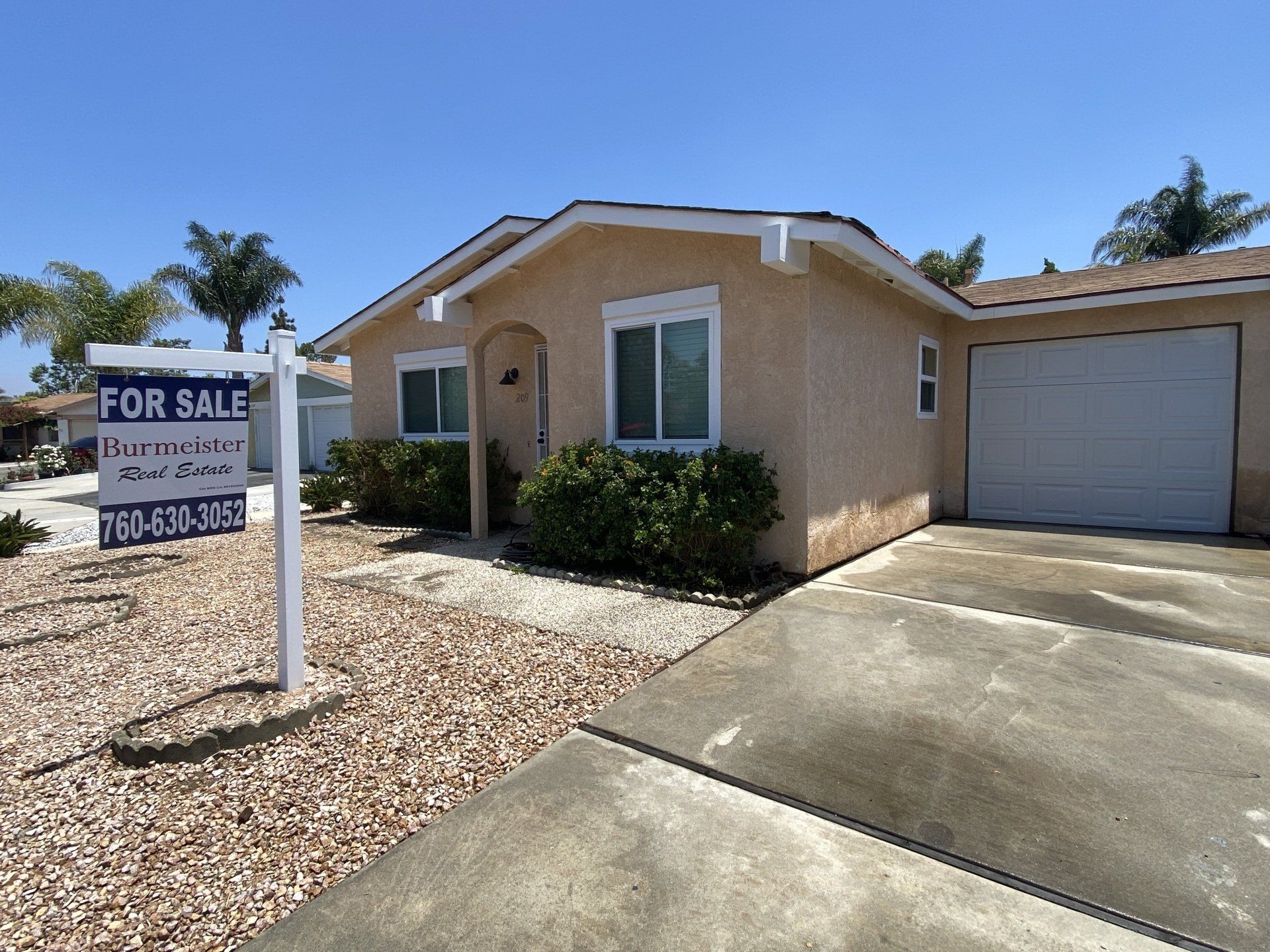 A house with a for sale sign in front of it
