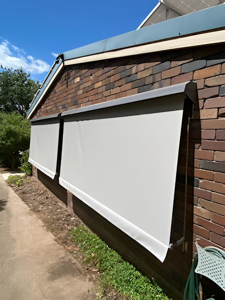 A Brick Building With a White Awning on the Side of It — Tamworth Blinds & Awnings in Tamworth, NSW