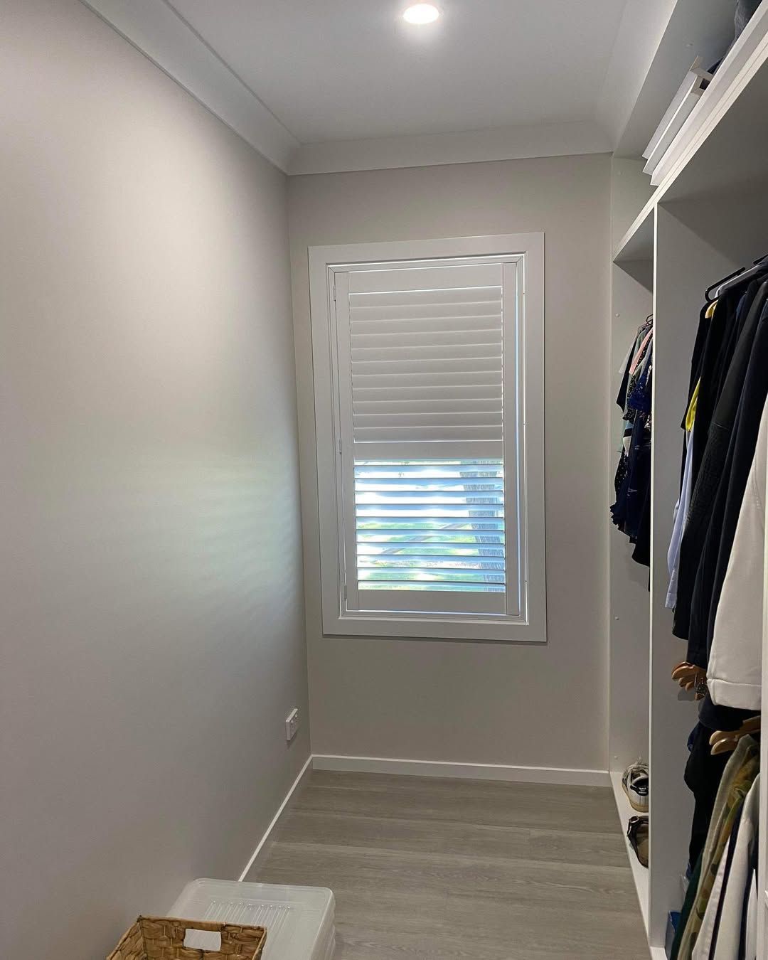 A Walk in Closet With a Window and Shutters — Tamworth Blinds & Awnings in Quirindi, NSW