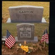 Two gravestones in a grassy field; one marked 