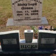 A headstone for Ricky Loyd Green above a companion monument marked with the surname HICKS in a cemetery setting.