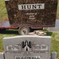 A large brown granite monument labeled 