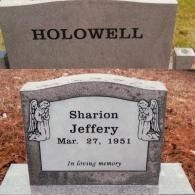 Two gray stone grave markers. One reads 