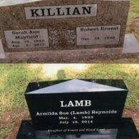 Two gravestones: one tan granite marked 