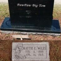 A black headstone engraved with 