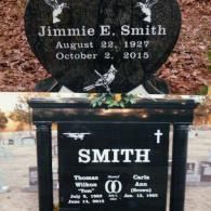 Two headstones for the Smith family: a heart-shaped one for Jimmie E. Smith and a rectangular one for Thomas and Carla Ann.