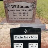 Two gravestones in a cemetery: one rose-colored for Karen Dee Williams, the other black with Masonic symbols for Dale Sexton.
