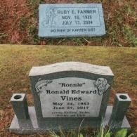 Two headstones in a cemetery: one for Ruby E. Farmer and a larger, engraved one for 