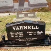 A black granite upright headstone engraved 