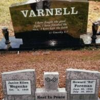 A black headstone engraved 