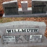 Three granite grave markers in a cemetery. One foreground marker reads 