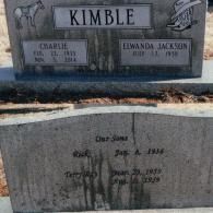 Two gray stone grave markers for the Kimble family, with engravings for parents Charlie and Elwanda and their two sons.