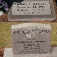 Two gray granite grave markers set in the grass; one for Michael J. Davidson and one for Kenneth E. 