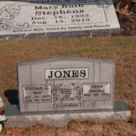 Two gray granite grave markers in a grassy cemetery, featuring the names Mary Ruth Stephens and the Jones family headstone.