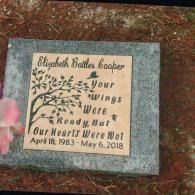 A granite memorial plaque with the text 