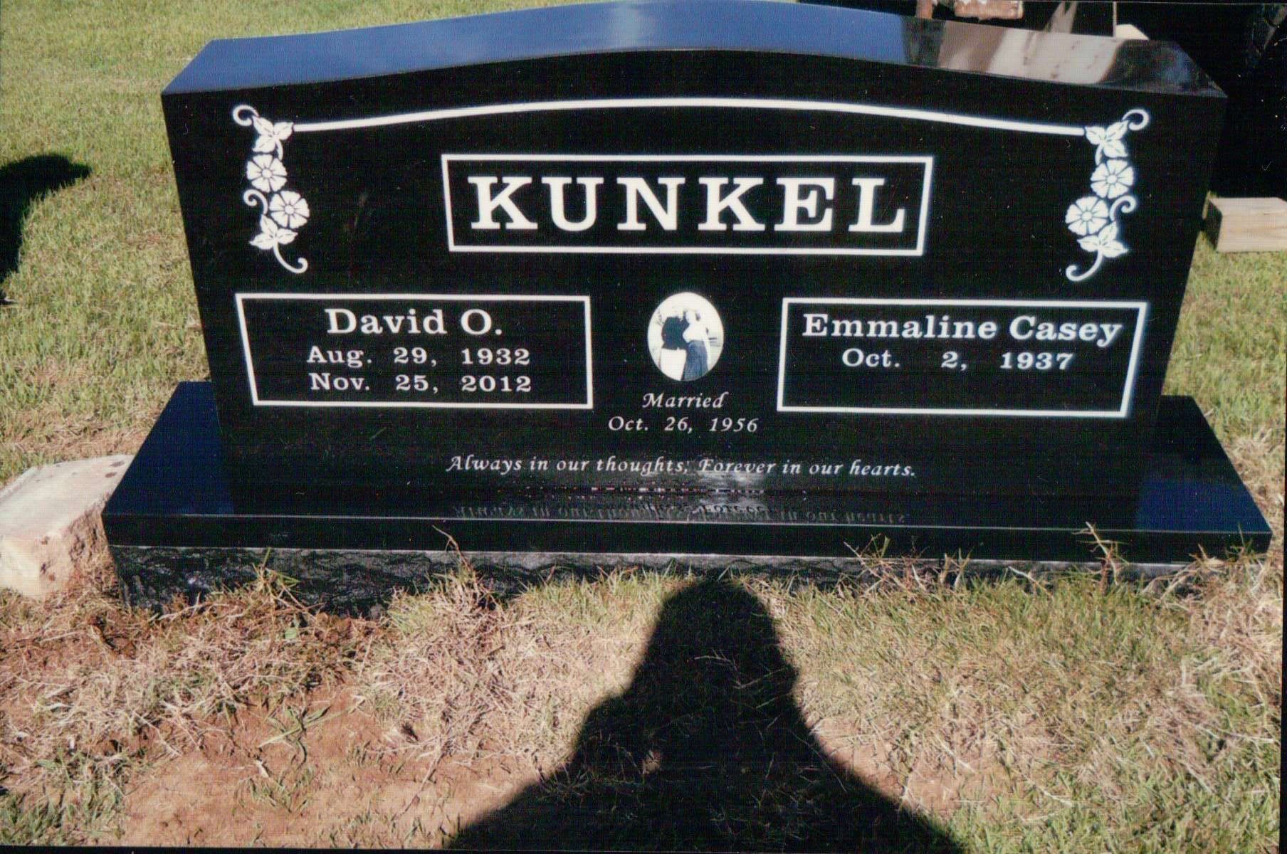 A black granite headstone for David O. and Emmaline Casey Kunkel, inscribed with their names and dates of life.