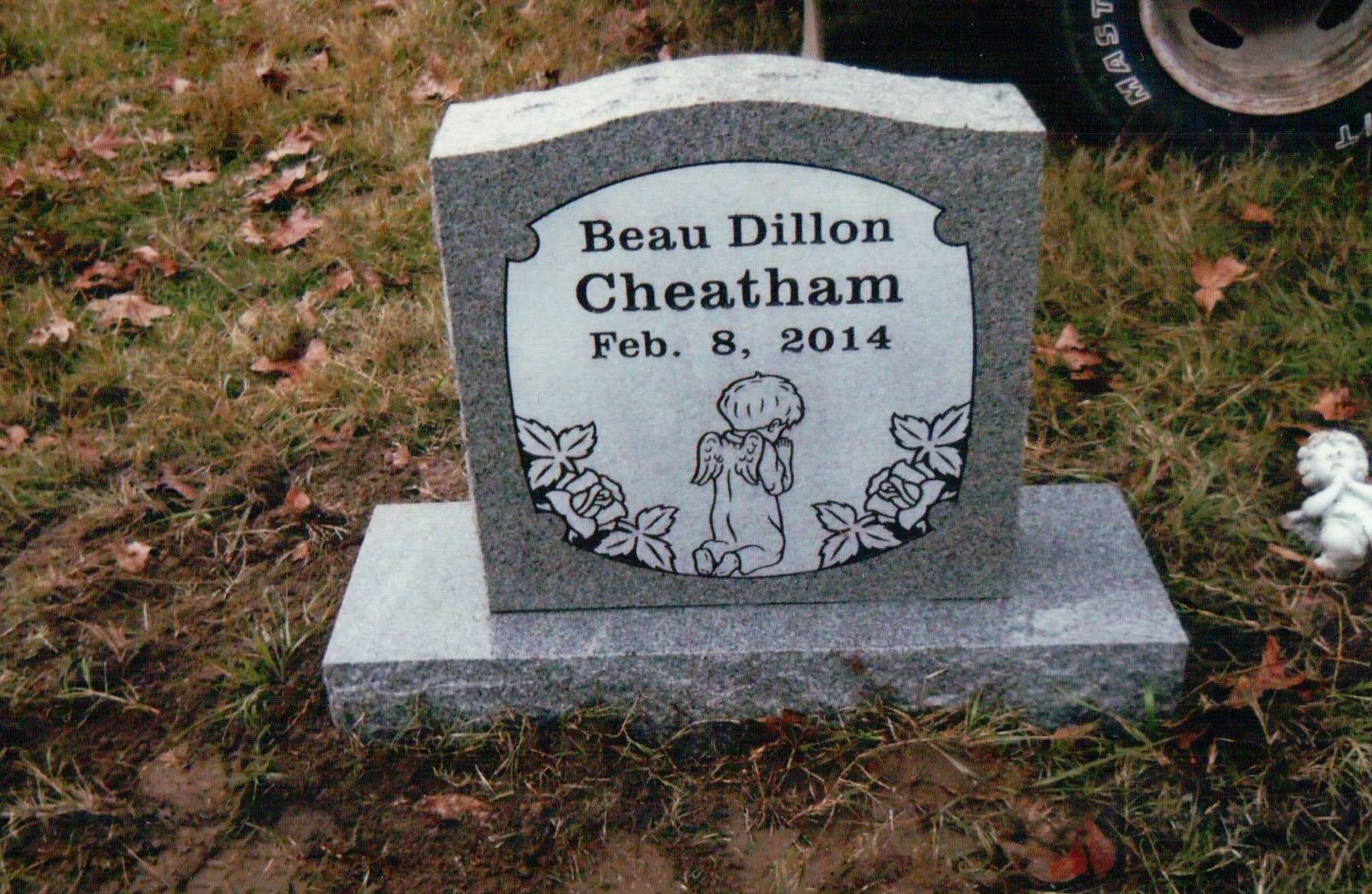 A gray granite tombstone engraved with 