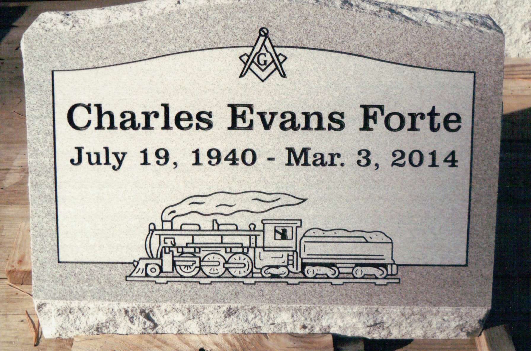 A gray granite headstone for Charles Evans Forte (1940–2014) featuring a Masonic symbol and a steam locomotive engraving.