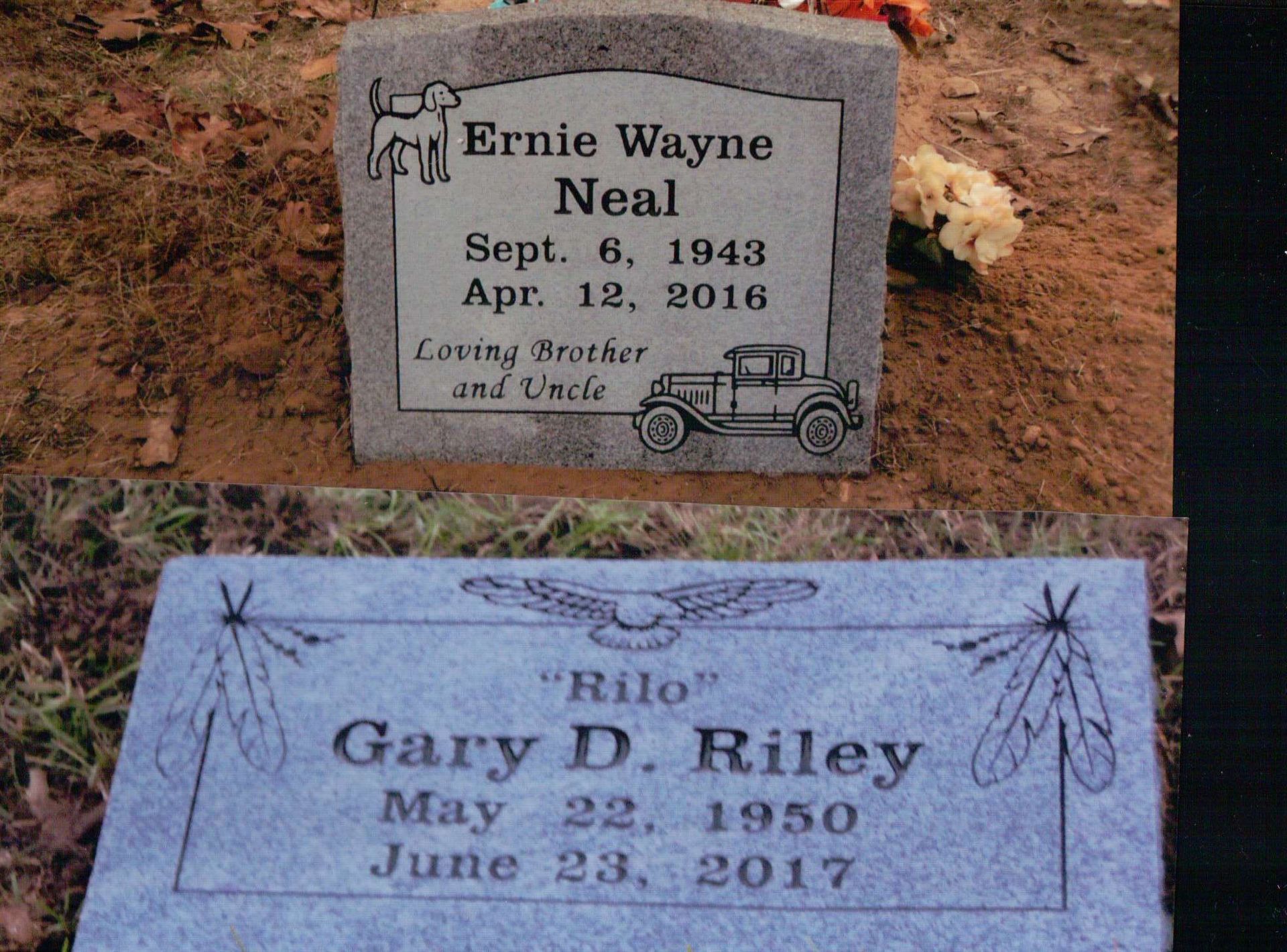 Two gray granite headstones with engraved names, dates of birth and death, and decorative illustrations.