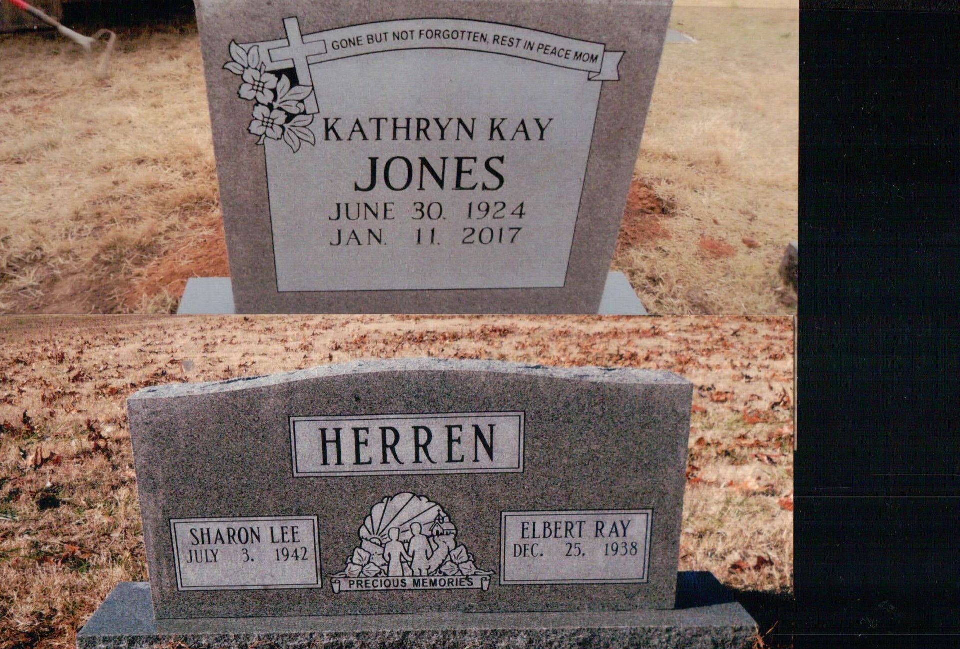 Two gray stone headstones in a cemetery; one reads 