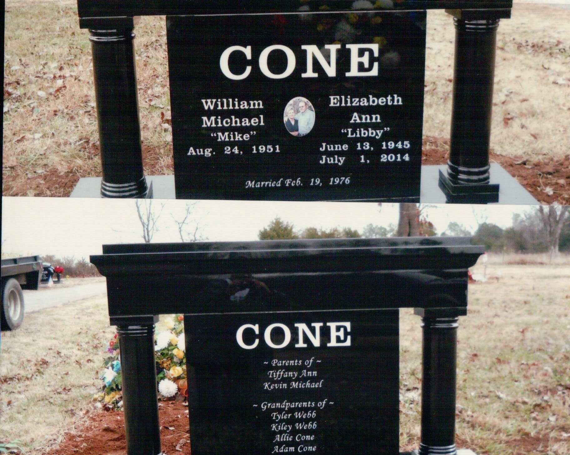 A double-sided black granite gravestone engraved 